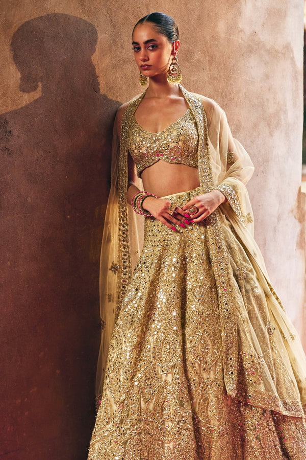Antique gold soft net bridal lehenga set with mirror work by Angad Singh