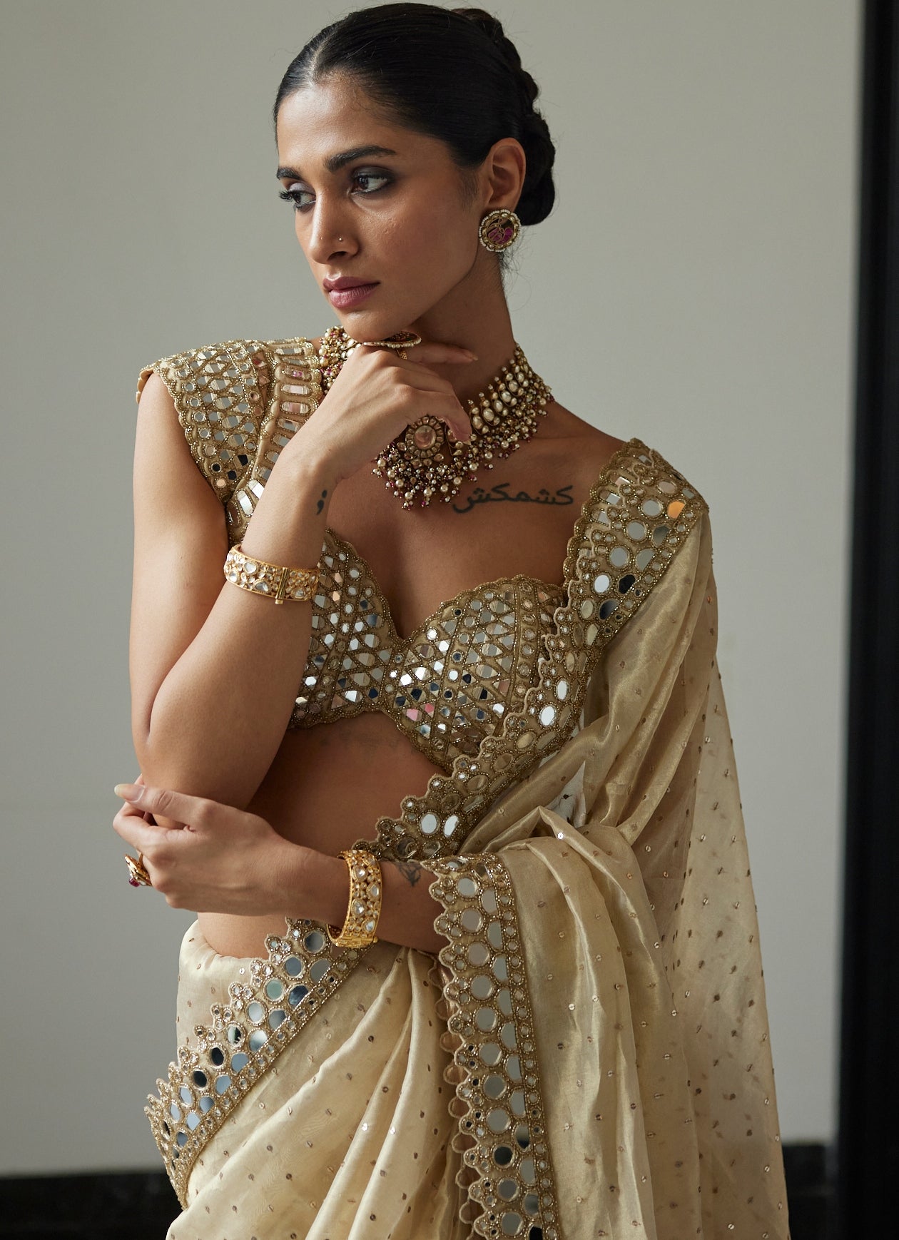 Beige gold mirror organza saree with half sleeve mirror blouse by Vvani by Vani Vats