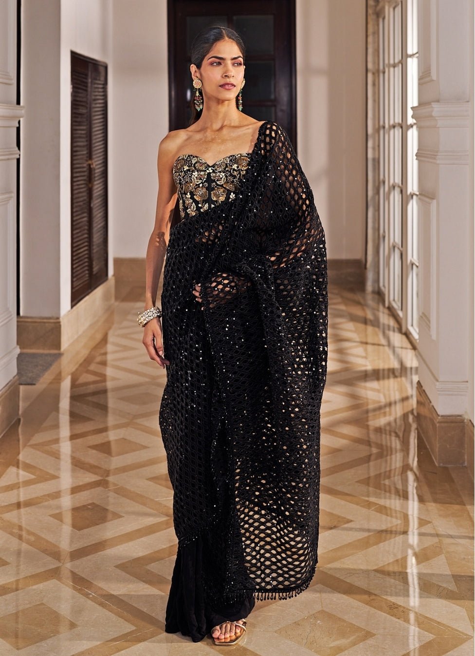 Black sequinned net cutwork saree set with corset by Nidhika Shekhar