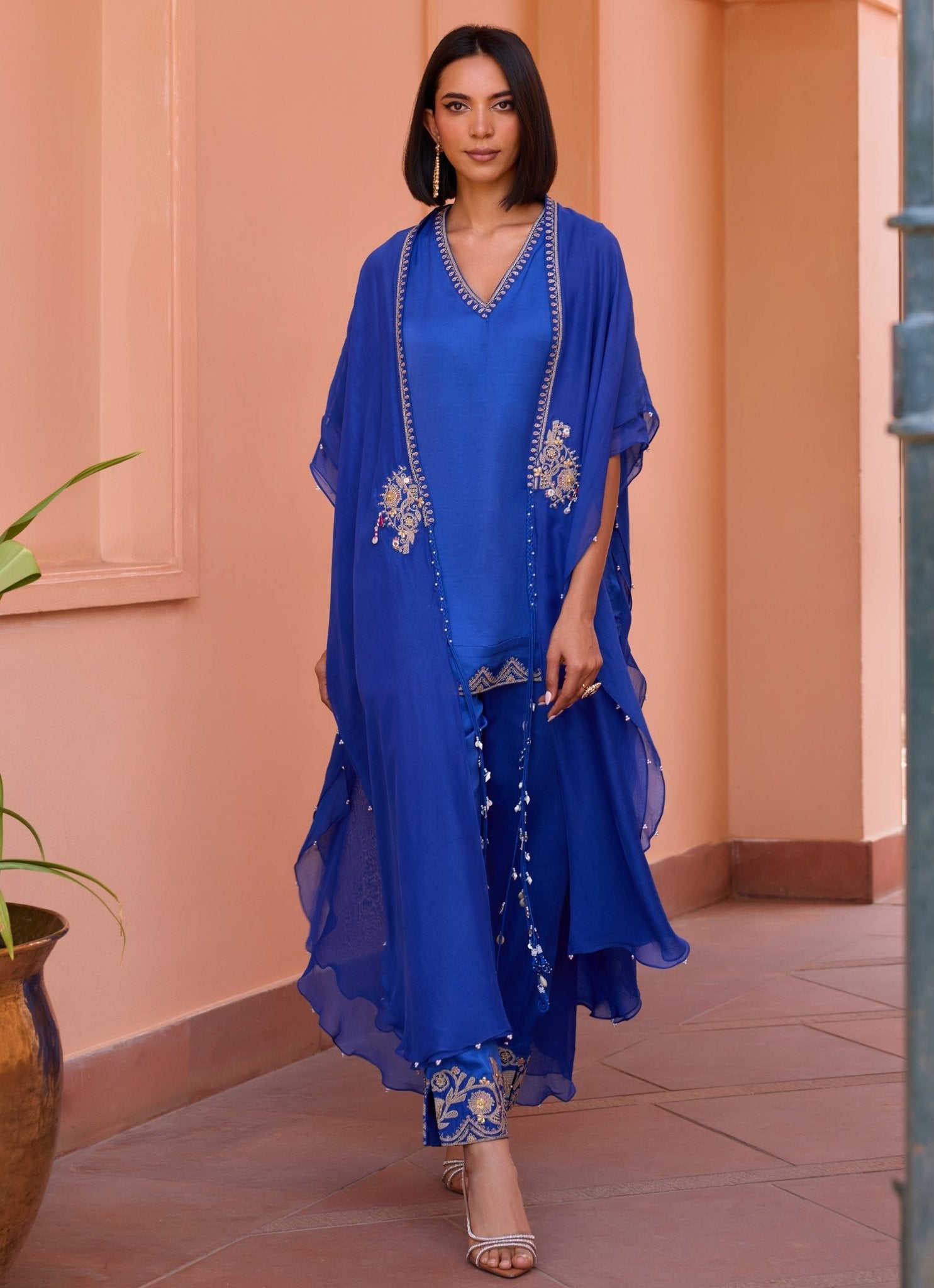 Blue embellished satin kurta set with cape by Isha Gupta Tayal — evening Rakhi outfit for sisters