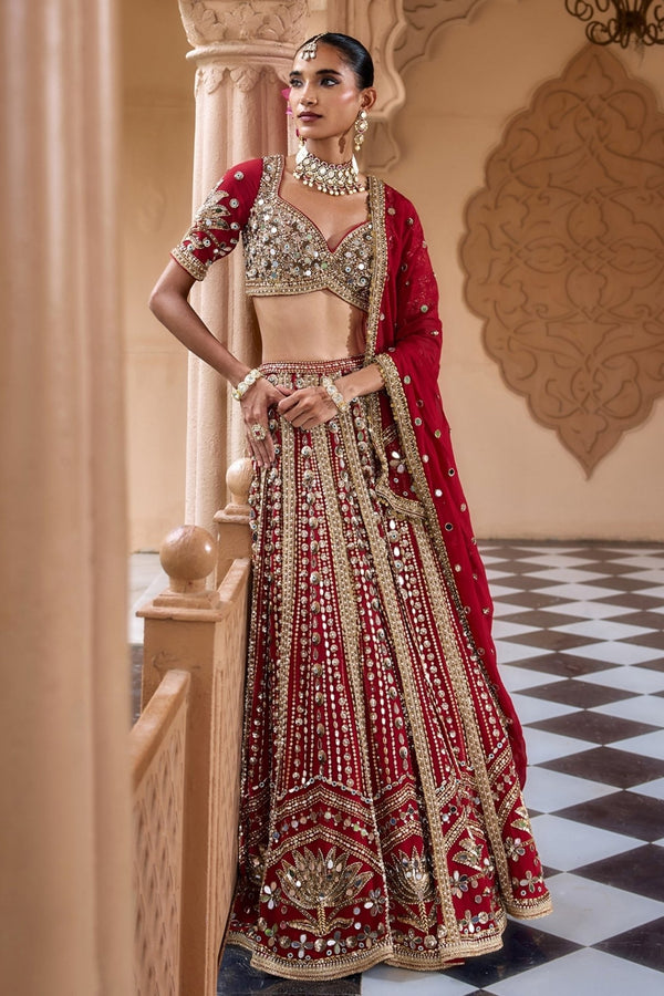 Deep red embroidered crepe bridal lehenga set with zardozi work by Nidhika Shekhar