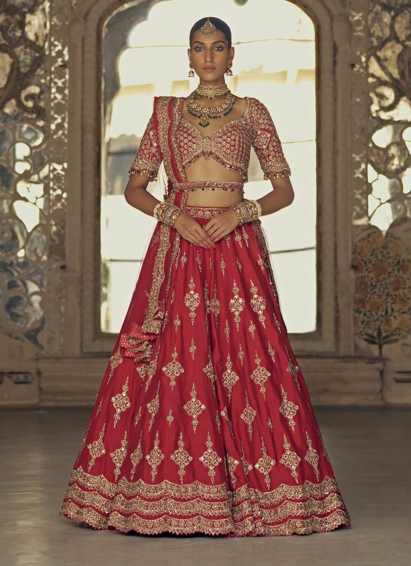 Deep red silk embroidered Nitika Gujral bridal lehenga