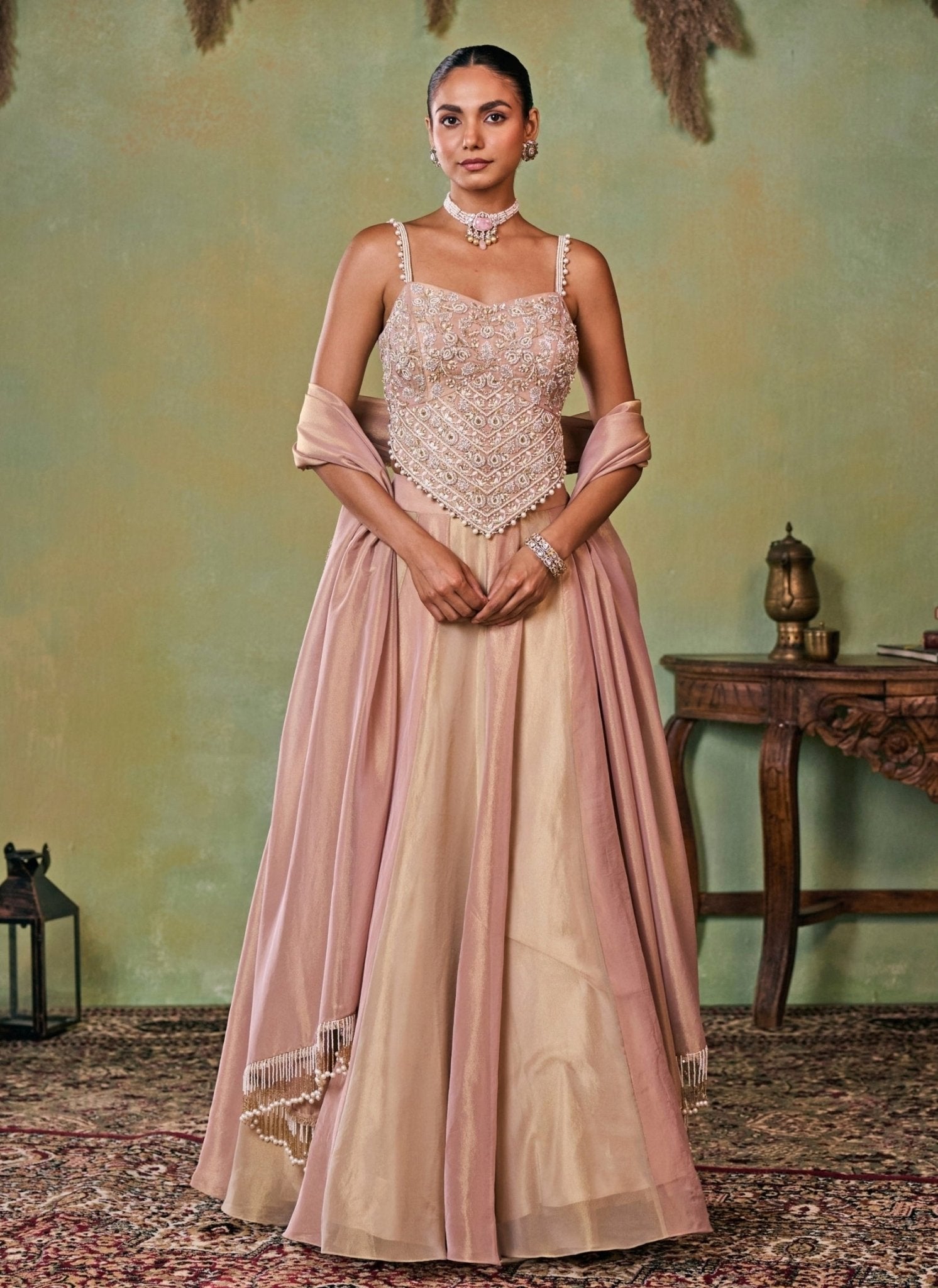 Dusty pink and gold tissue corset lehenga set by Seema Thukral