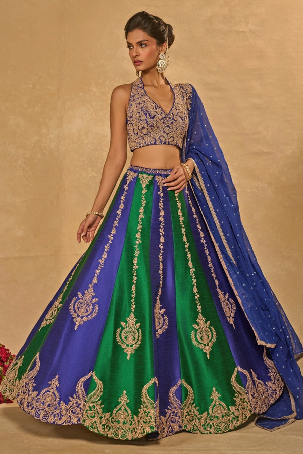 Green and blue dupion silk lehenga by Chamee and Palak for the sister of the groom at an Indian wedding