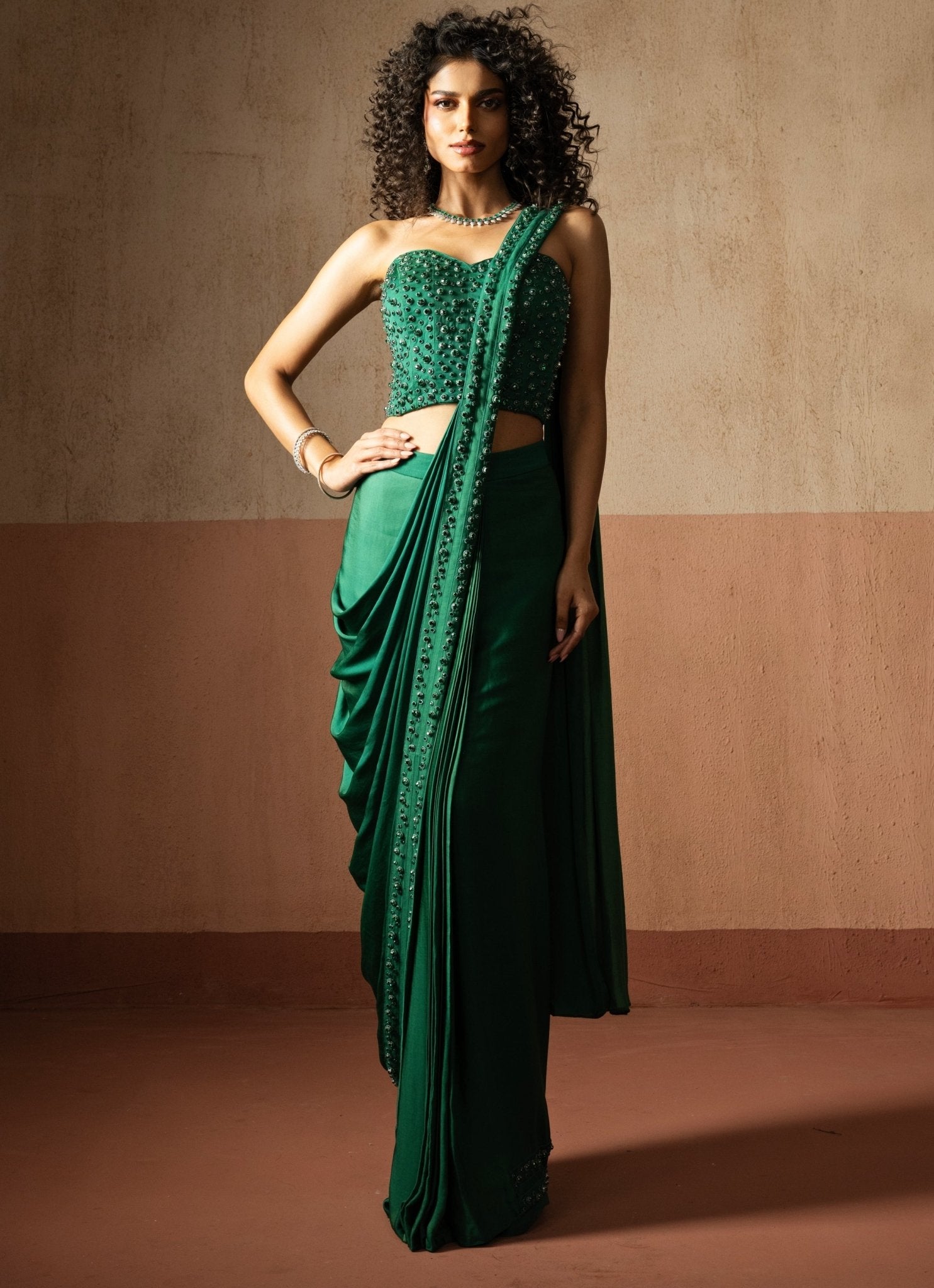 Green pre-draped satin saree with corset blouse by Quench a Thirst
