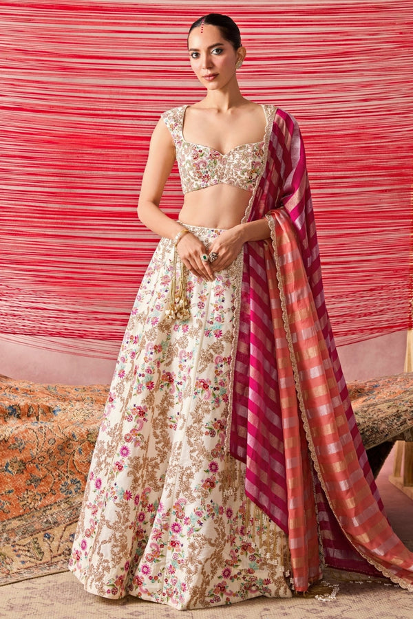 Ivory and multicolour dupion silk lehenga set by Chamee and Palak for the bride's reception