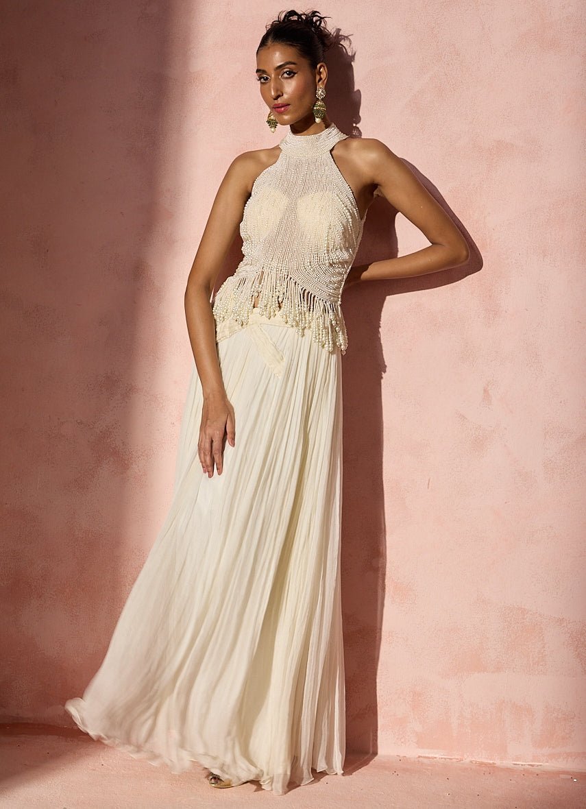 Ivory chiffon pleated skirt set with halter top by Nitika Gujral for destination wedding bride
