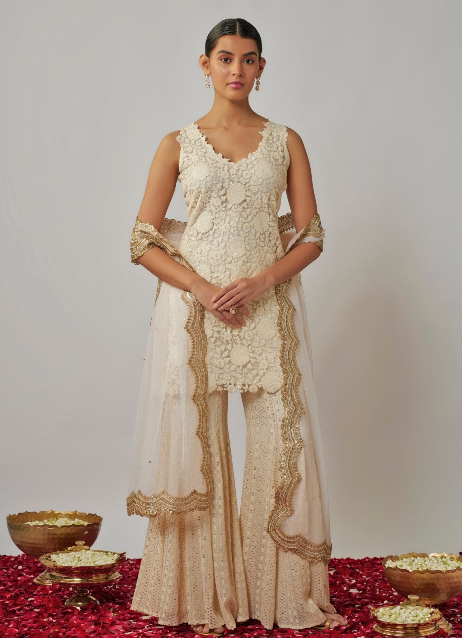 Amrita Sangha wearing an ivory kurta sharara set for wedding guest dressing in the UK