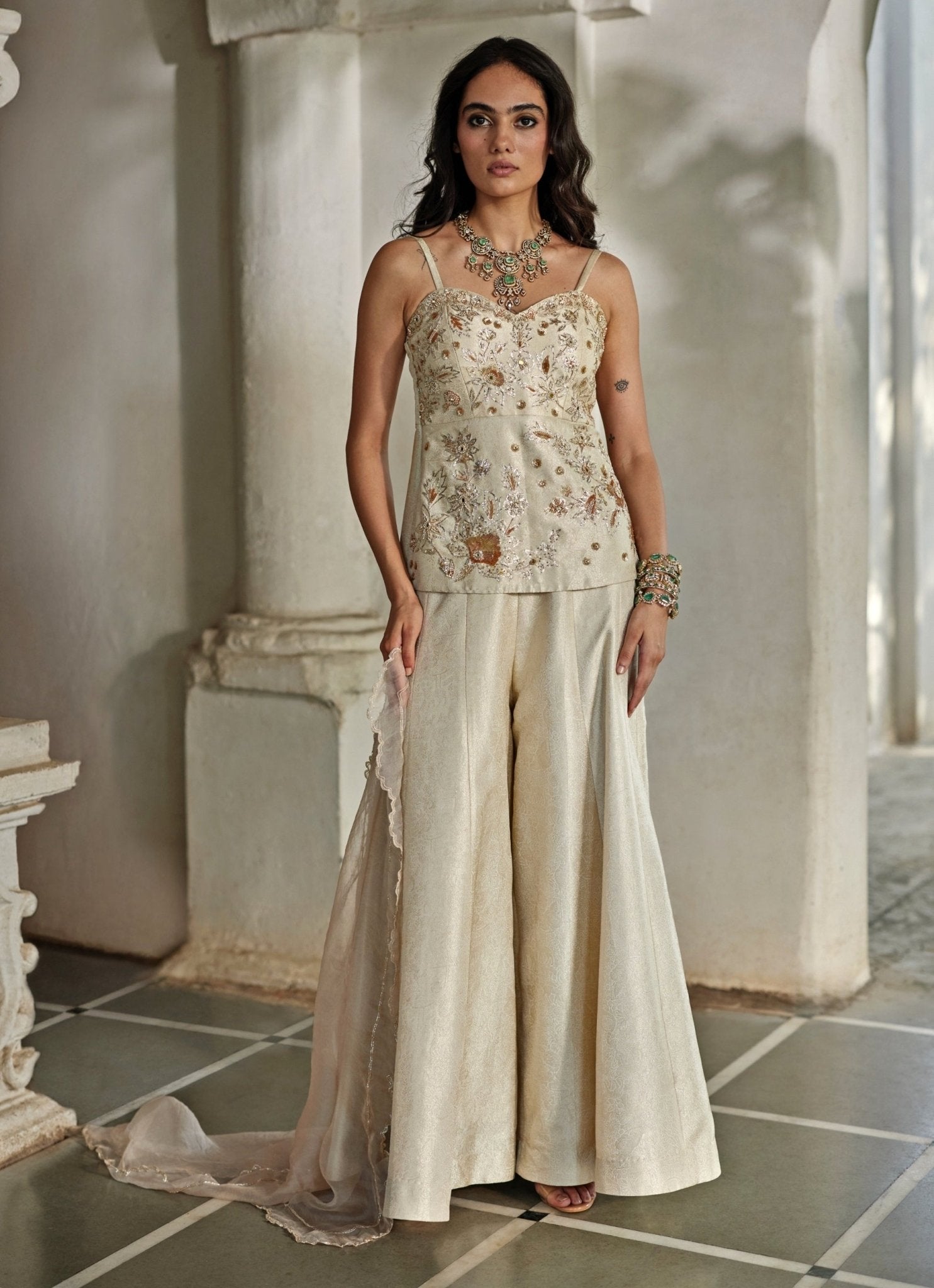 Ivory jamavar palazzo set with corset kurta by Paulmi and Harsh