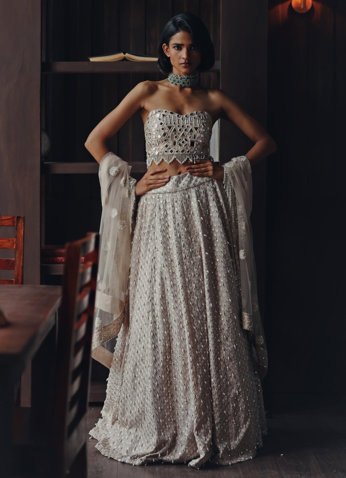 Waist-emphasising dupatta drape styled over both arms in a lehenga guide for body type
