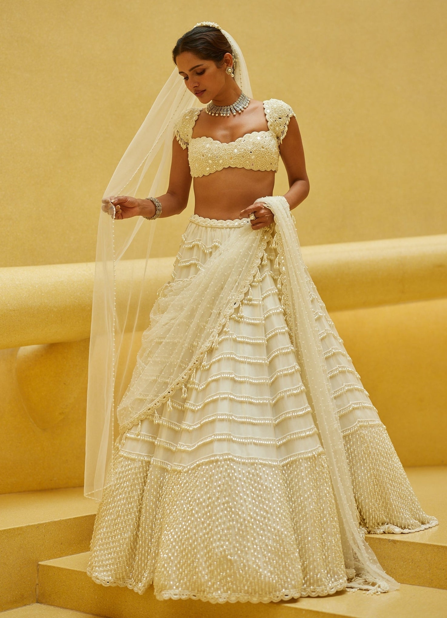 Ivory mirror and pearl embroidered bridal lehenga with veil by Vvani by Vani Vats
