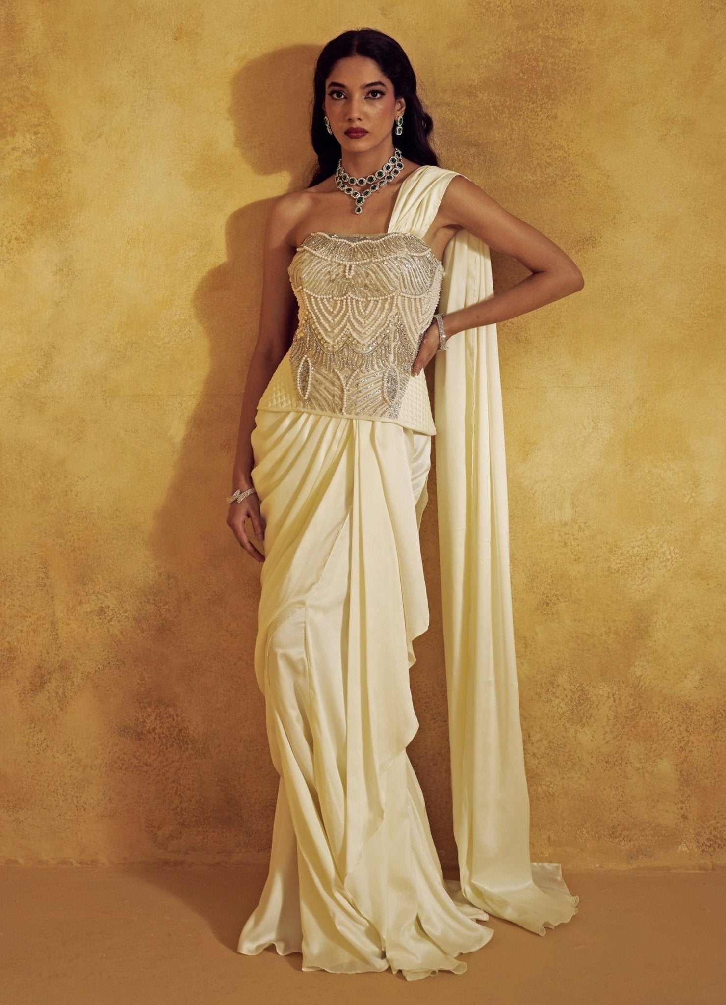 Ivory satin pre-draped corset saree for the bride-to-be by Rashika Sharma
