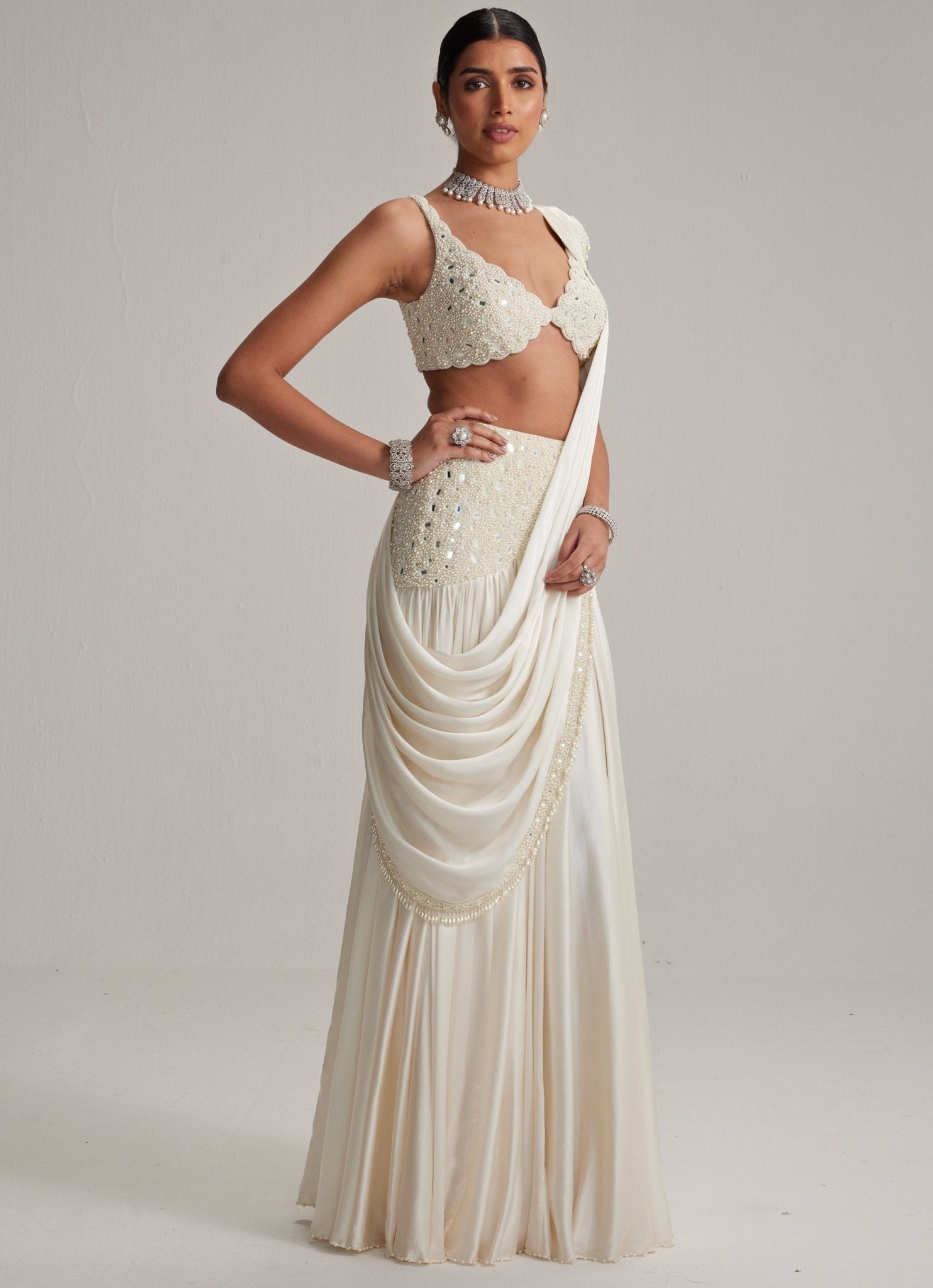 Ivory satin saree with pearl blouse for elegant wedding guest styling