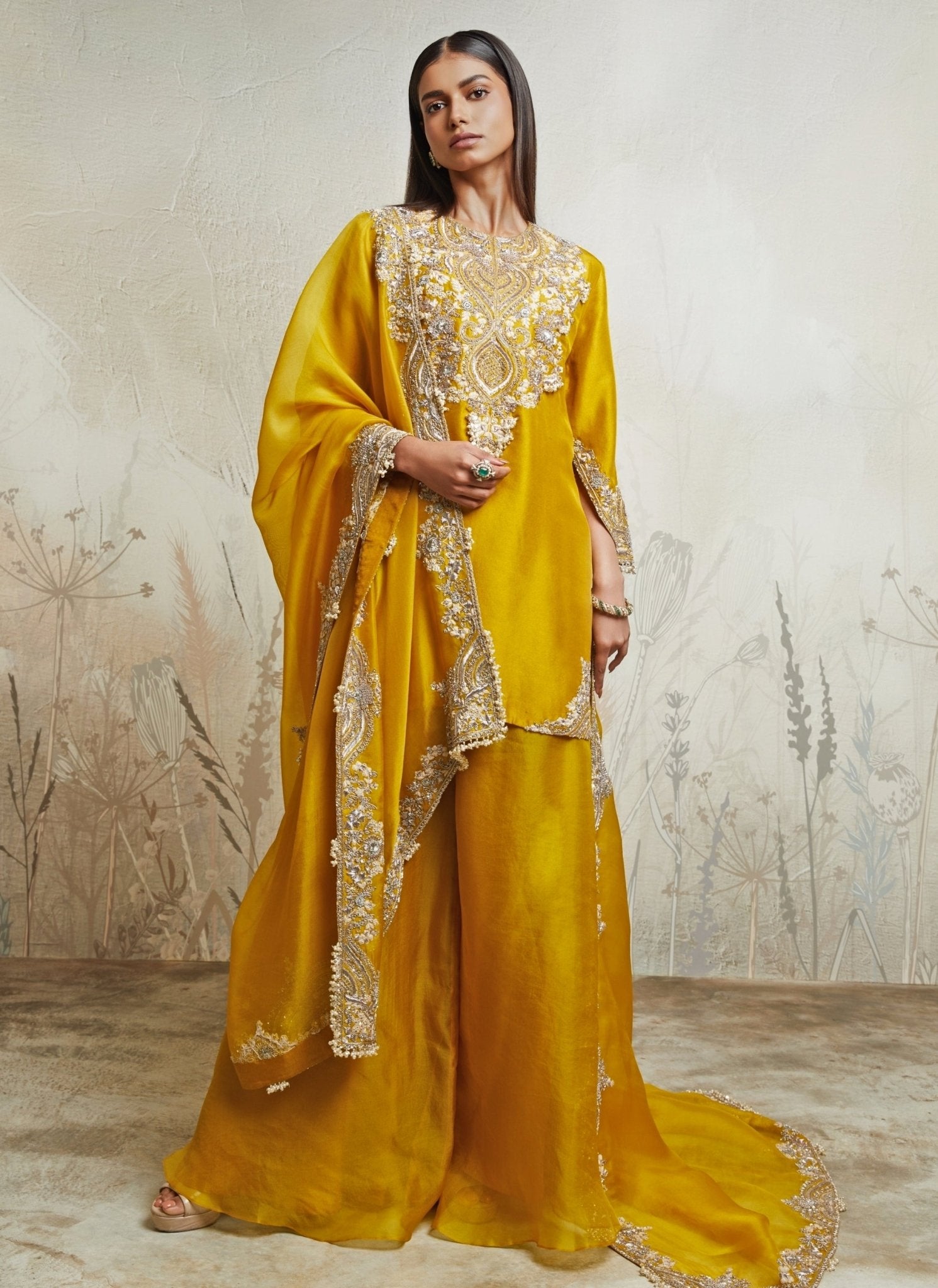 Mustard yellow silk kurta sharara set for the groom's sister at a Punjabi Sangeet