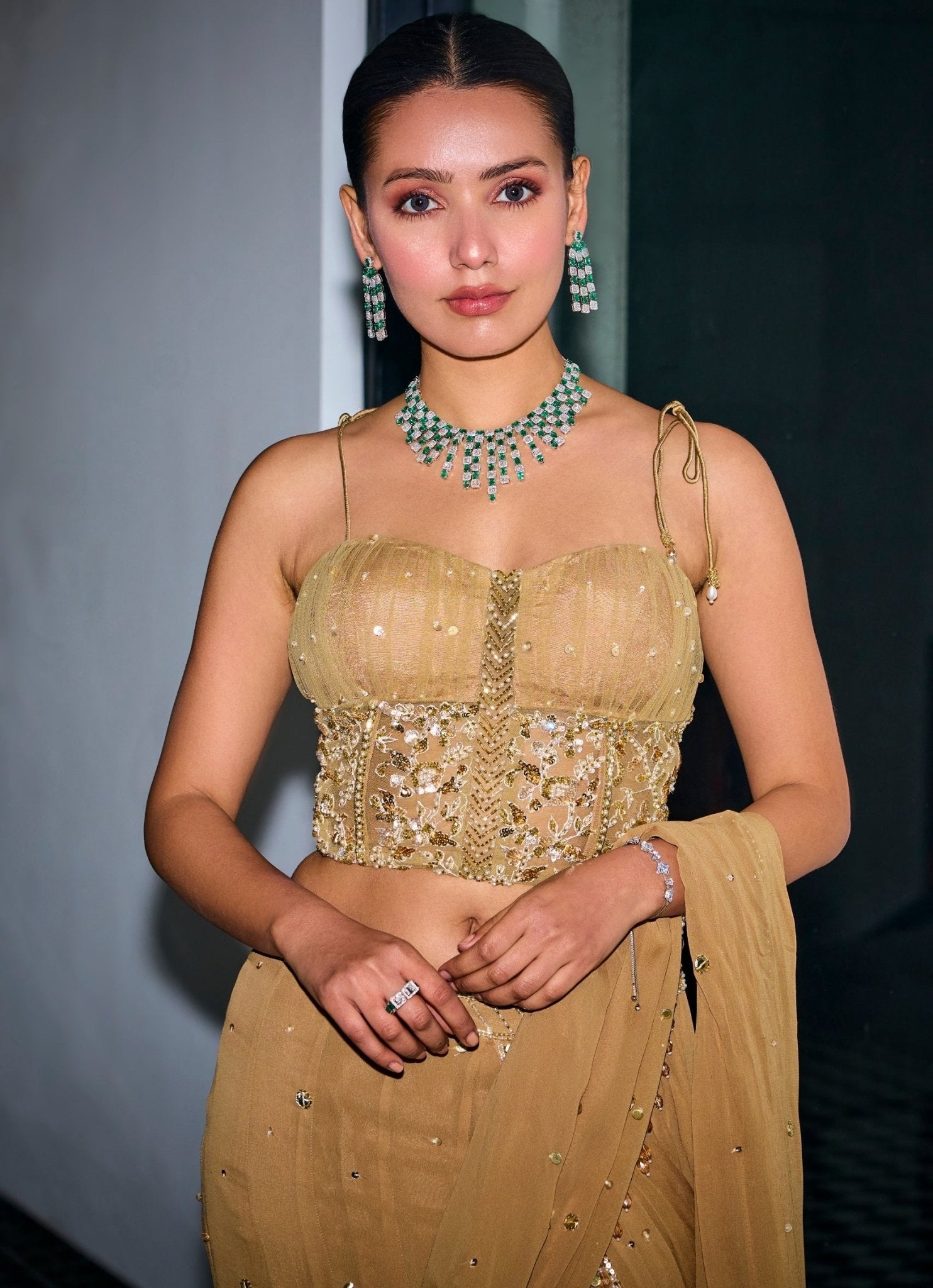 Nude gold sequins georgette pre-draped corset saree for party wear by Sanya Gulati