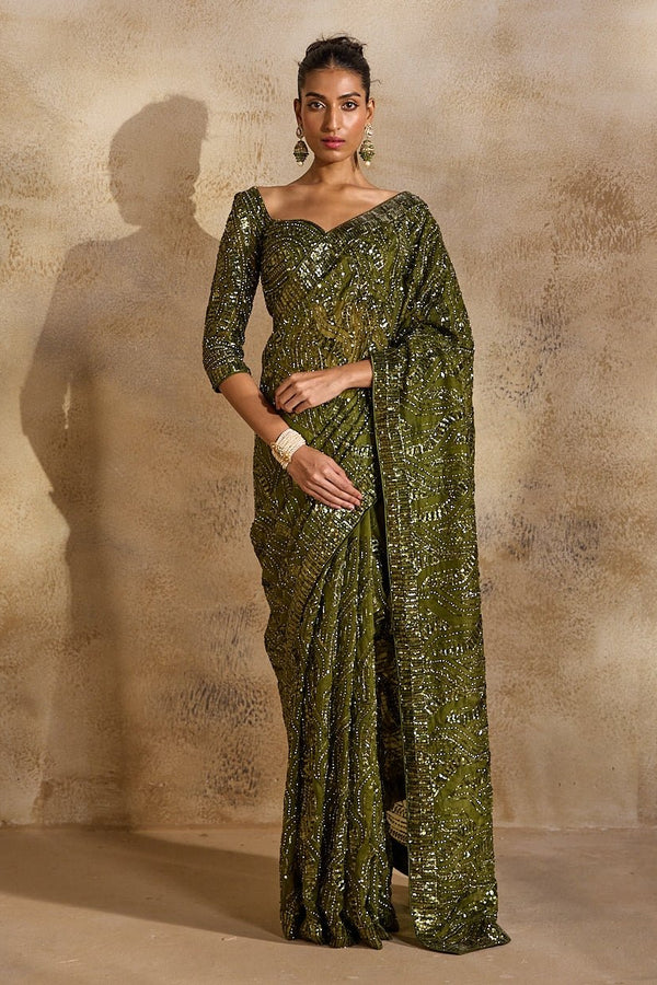 Olive green organza saree by Nitika Gujral for the mother of the bride in a coordinated family palette
