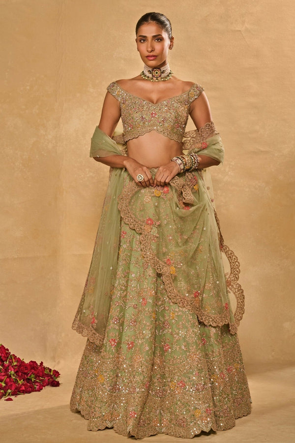 Pastel green organza lehenga by Chamee and Palak for the sister of the bride in coordinated family outfits