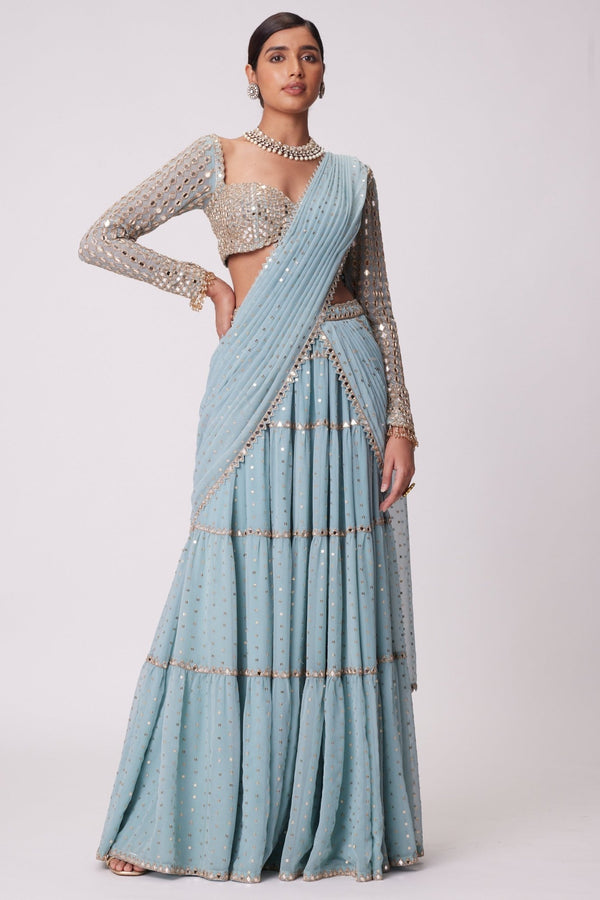 Blue multi-tier saree with embroidered mirror blouse by Vvani by Vani Vats