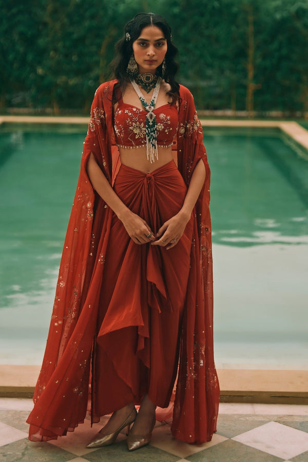Red printed organza draped skirt set with cape by Paulmi and Harsh