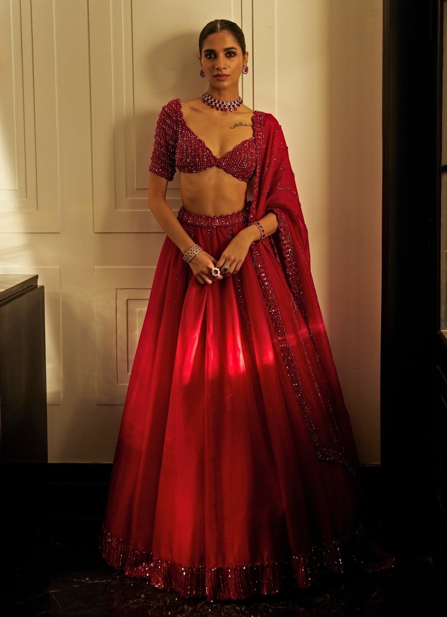 Ruby red crystal and sequin embroidered organza lehenga set by Vvani by Vani Vats
