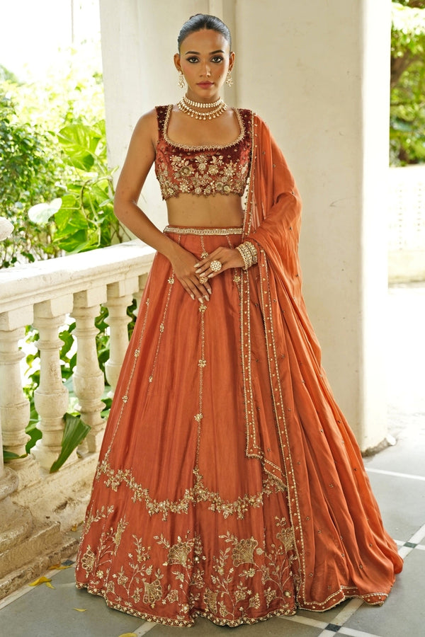 Rust brown embroidered silk lehenga set with velvet blouse for a London wedding reception
