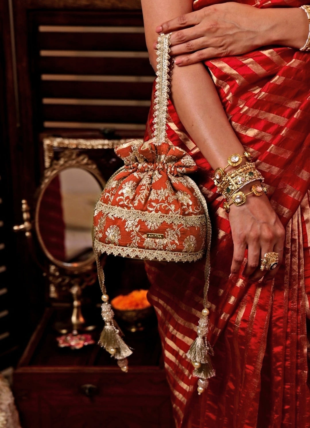 Amyra Rust Orange Embroidered Base PotliFabilicious Fashion
