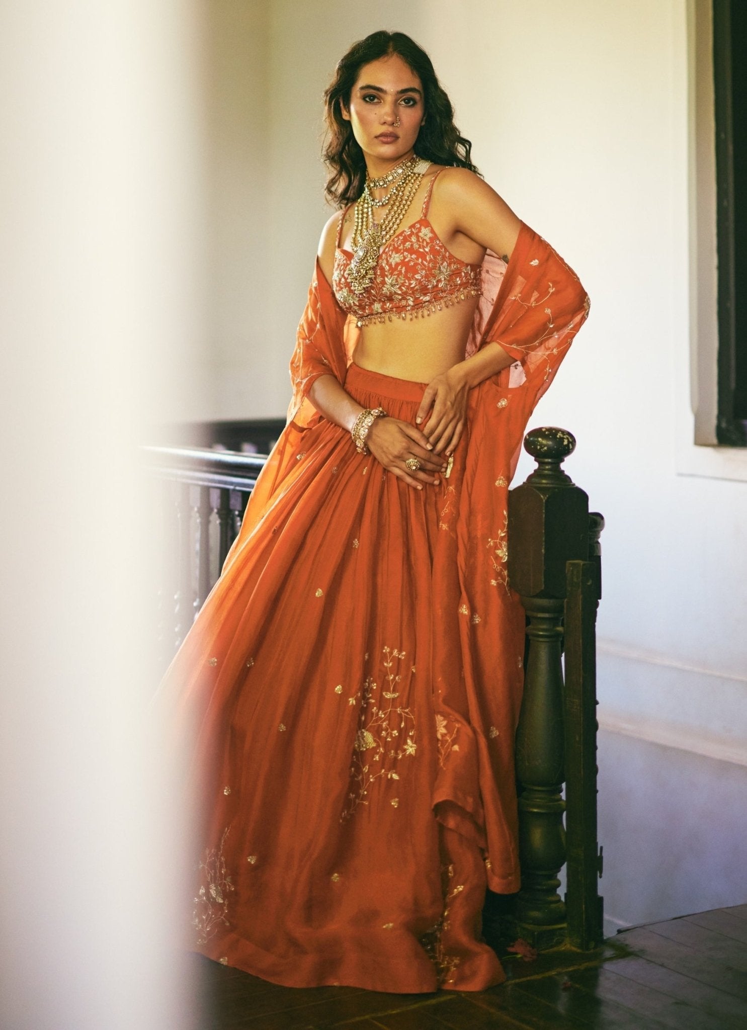 Rust orange organza lehenga for mehendi by Paulmi and Harsh
