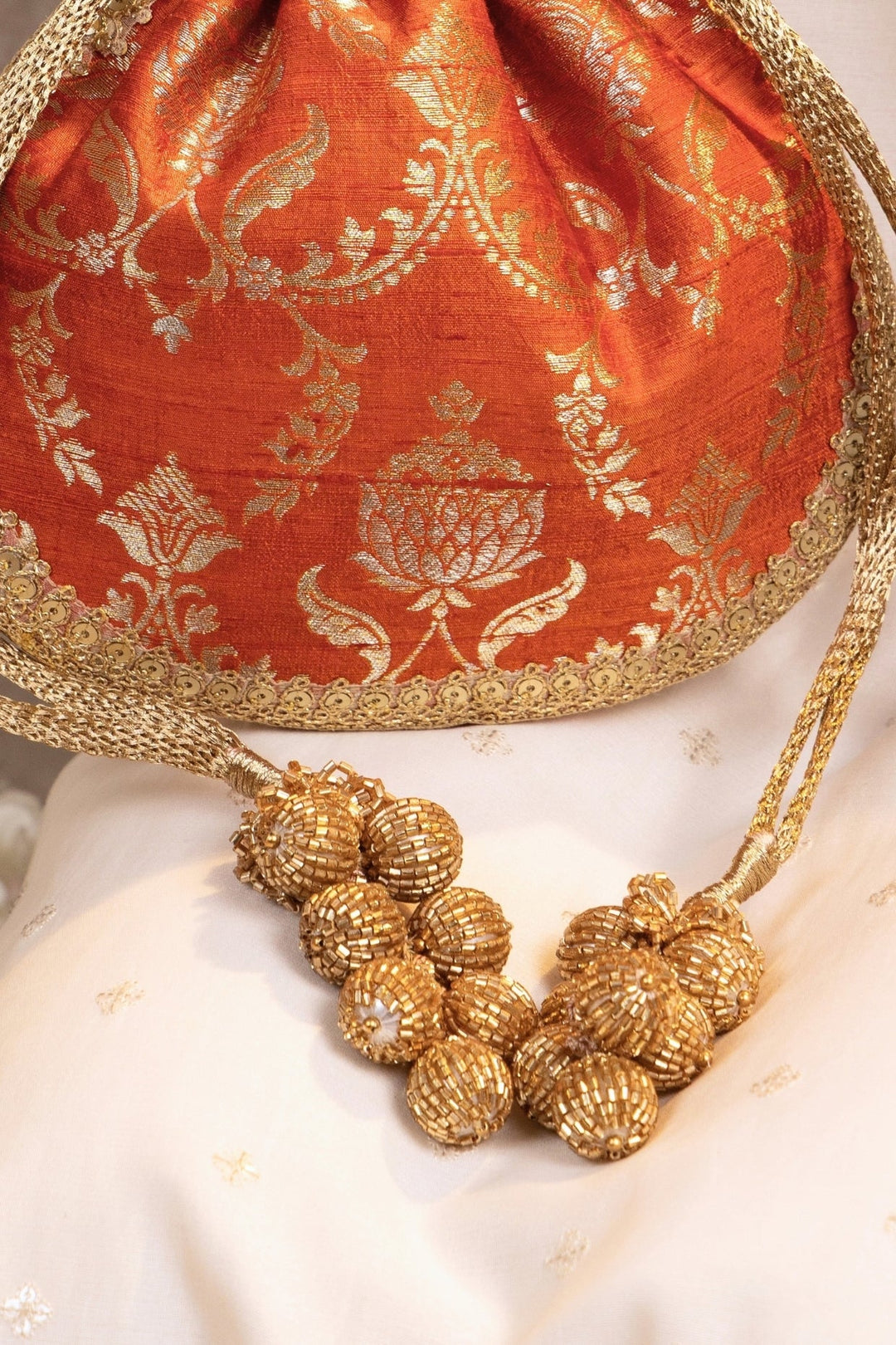 Amyra Rust Orange Raw Silk Embroidered PotliFabilicious Fashion