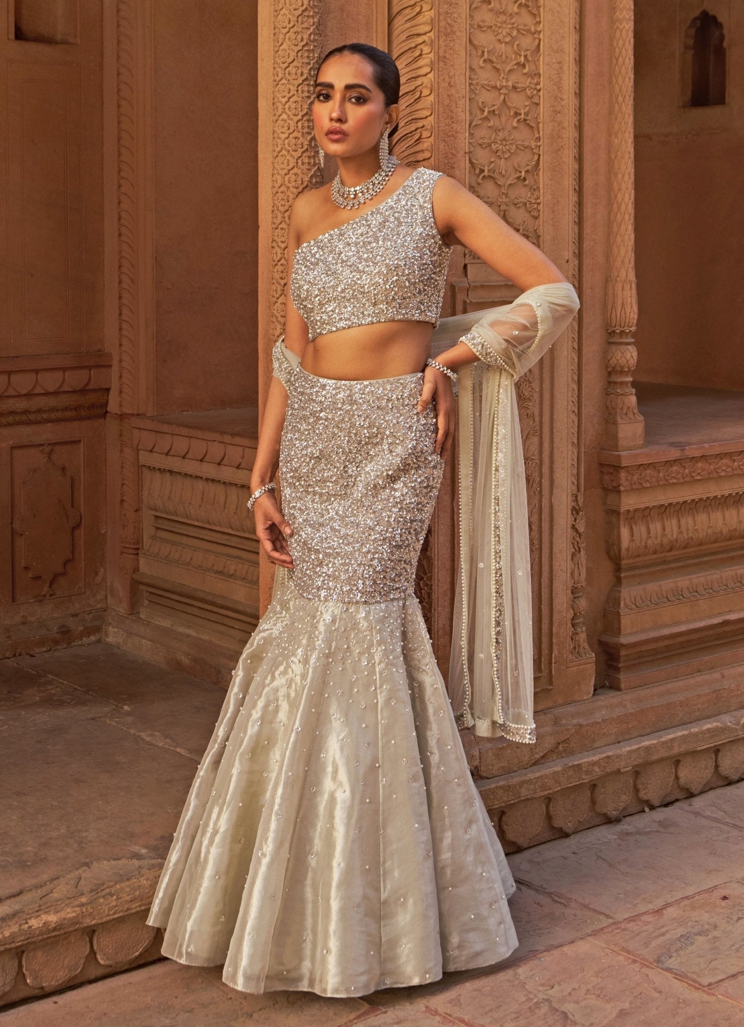 Silver one shoulder mermaid lehenga for wedding reception by Nidhika Shekhar