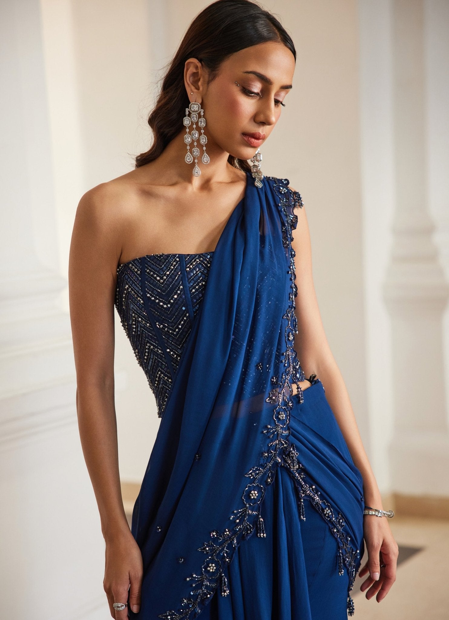 Teal blue embroidered georgette corset bustier saree for wedding guests by Sanya Gulati