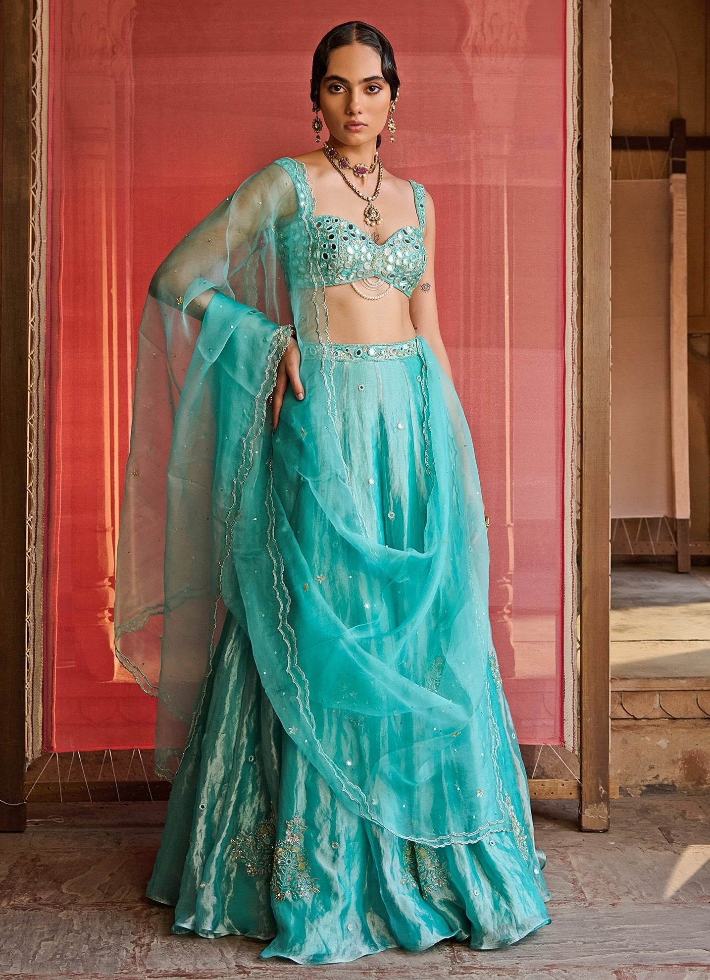 Turquoise blue embroidered tissue lehenga — luminous sangeet lehenga that glows under lights