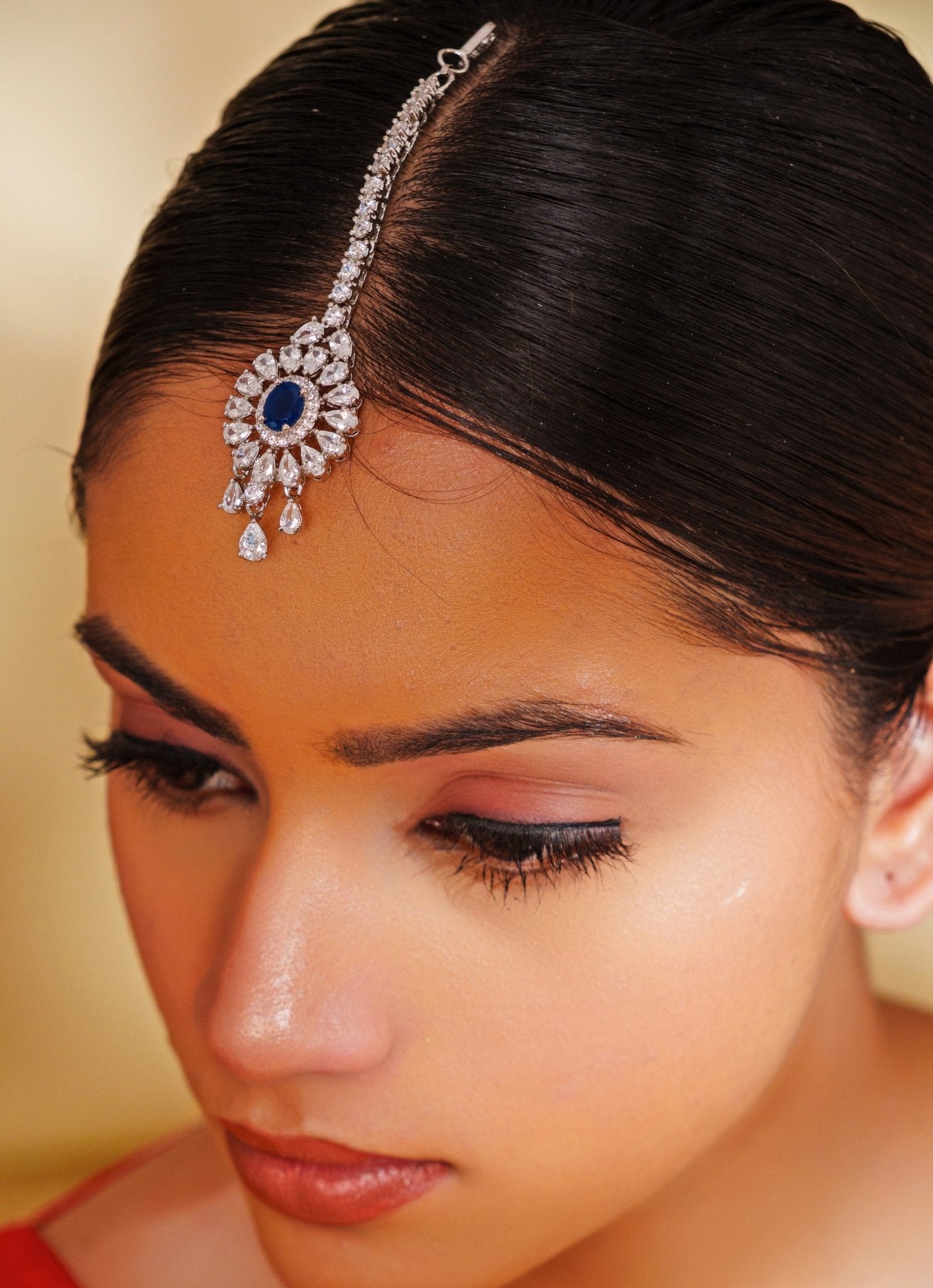 White finish diamond and blue sapphire maang tikka by Zevar by Geeta for wedding guests