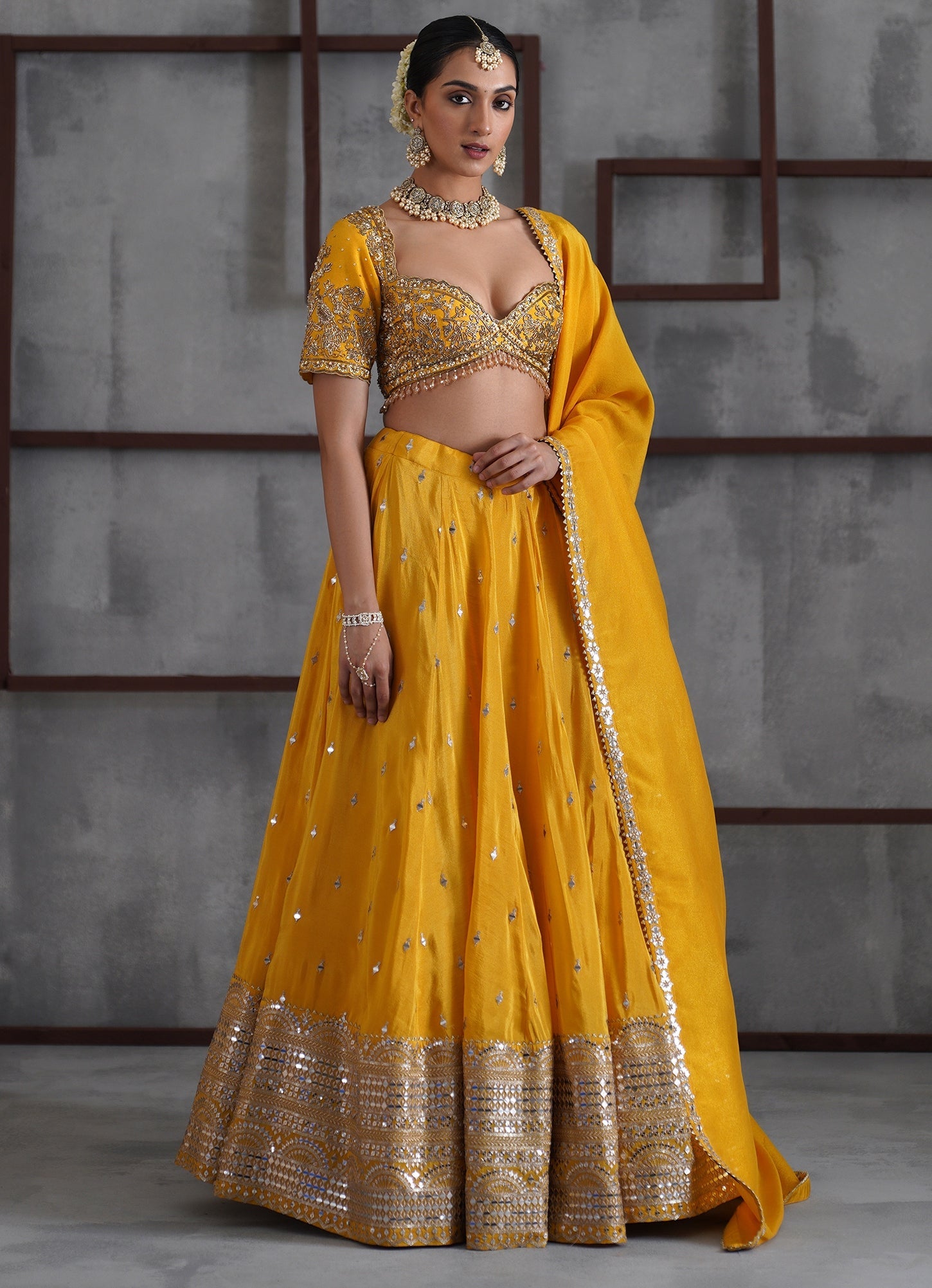 Yellow embroidered tissue bridal lehenga by Deepika Chadha for haldi