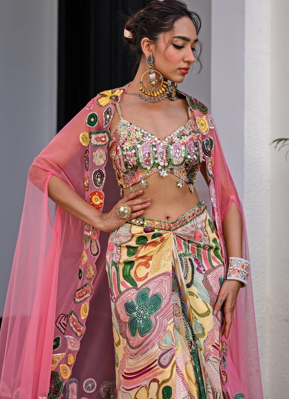 Yellow printed satin dhoti skirt with cutwork applique cape by Juhi Bengani, styled for a destination wedding