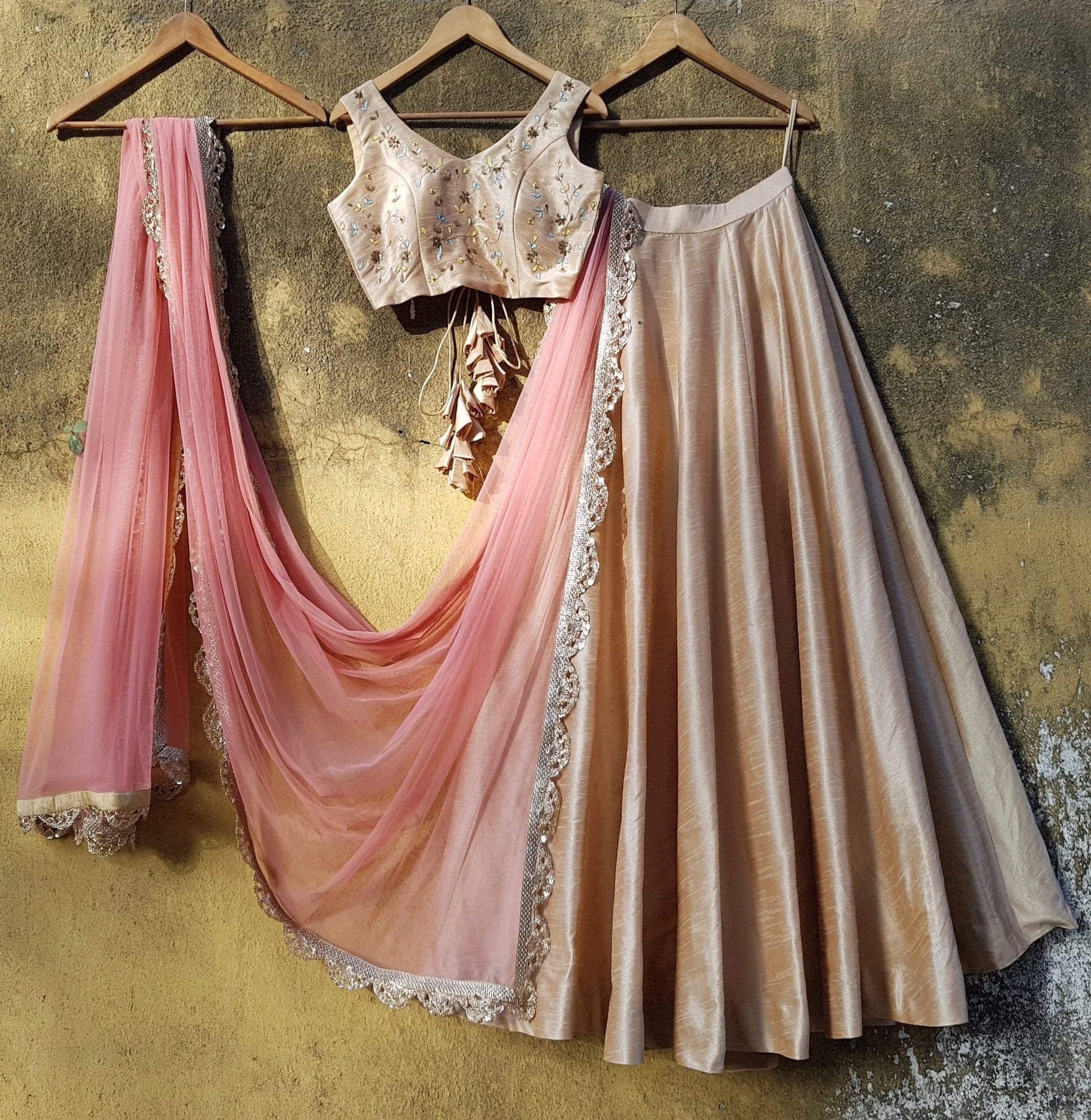 Beige silk wedding guest lehenga with pink scallop dupatta