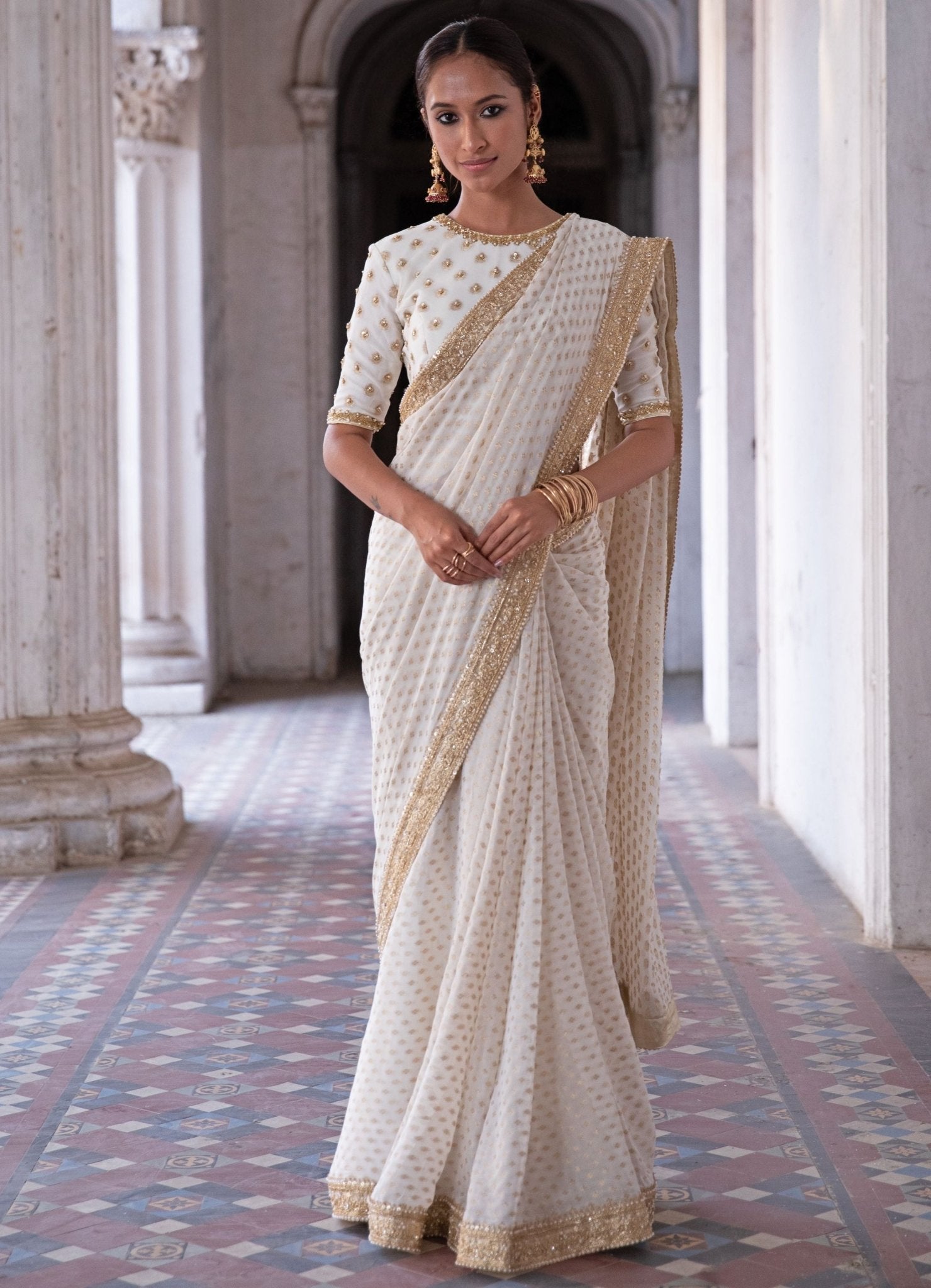 Indian bride in traditional red banarasi saree with gold jewelry