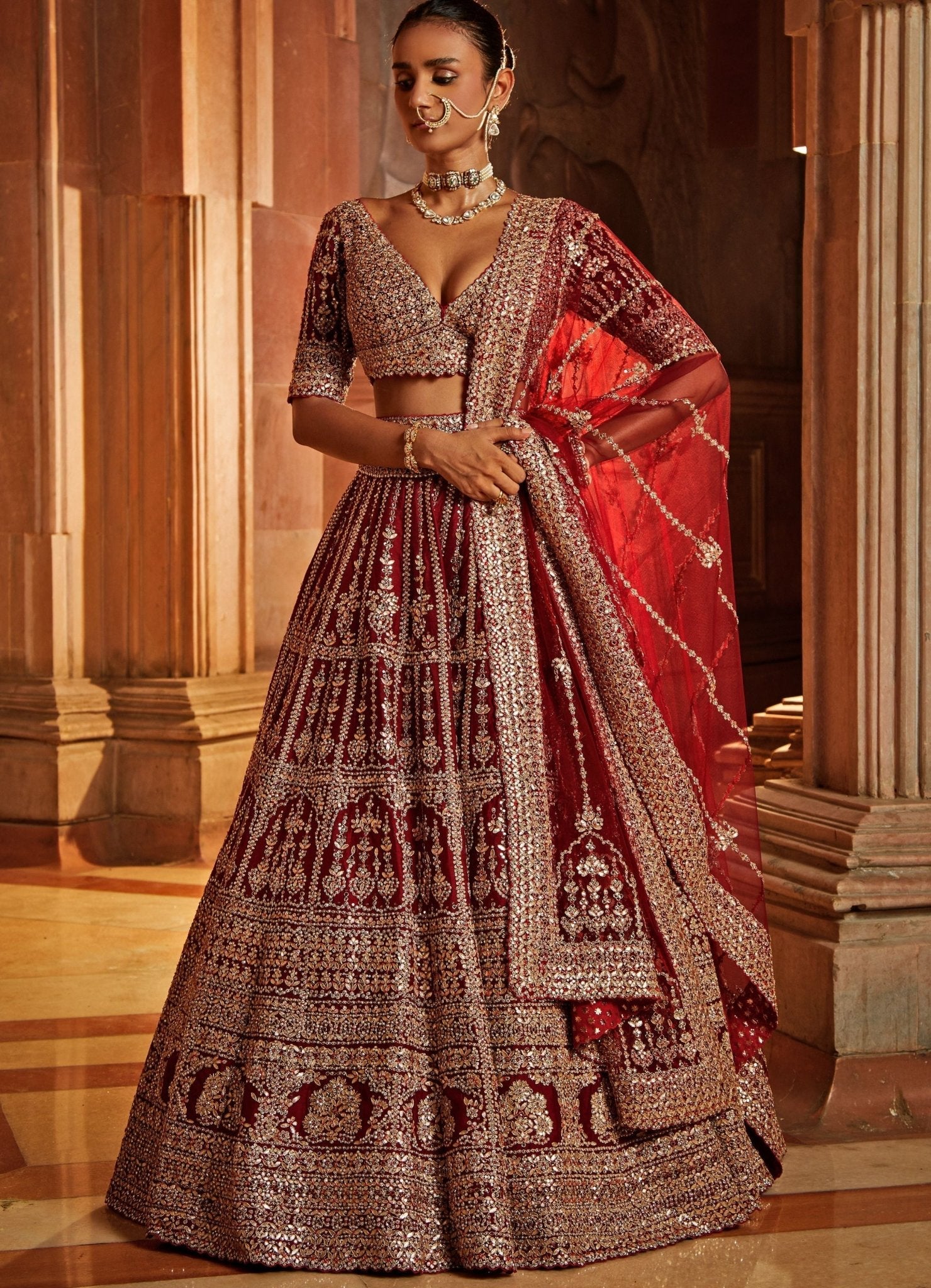 Maroon raw silk Nitika Gujral lehenga with belt and tulle dupatta