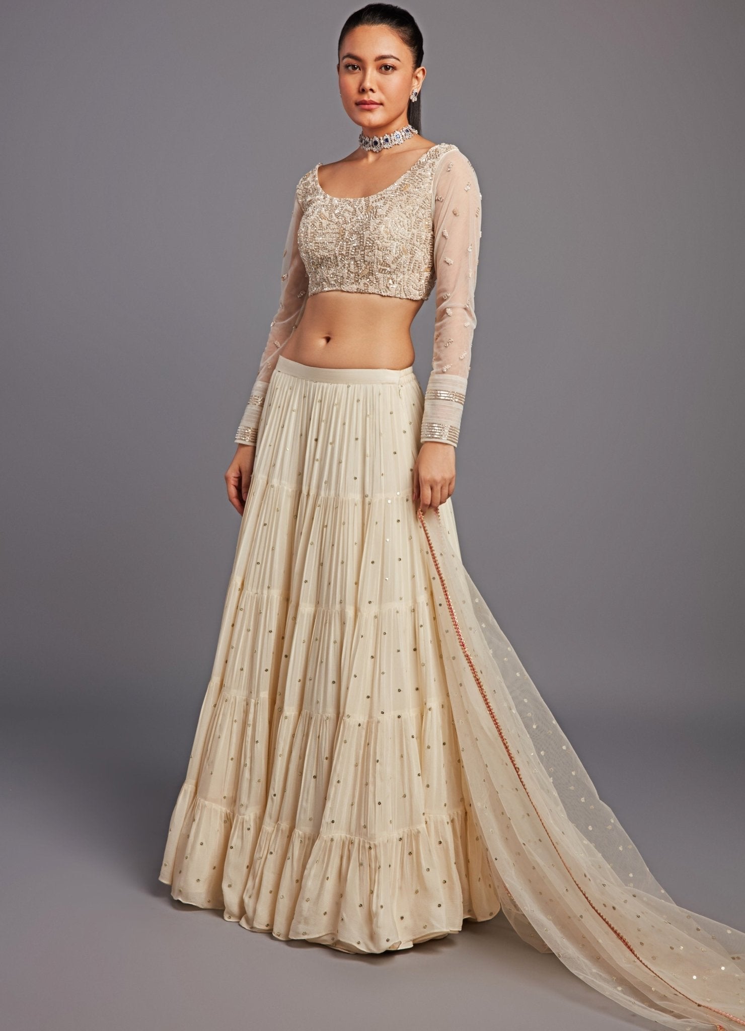 Ivory tiered lehenga with a modern open blouse neckline