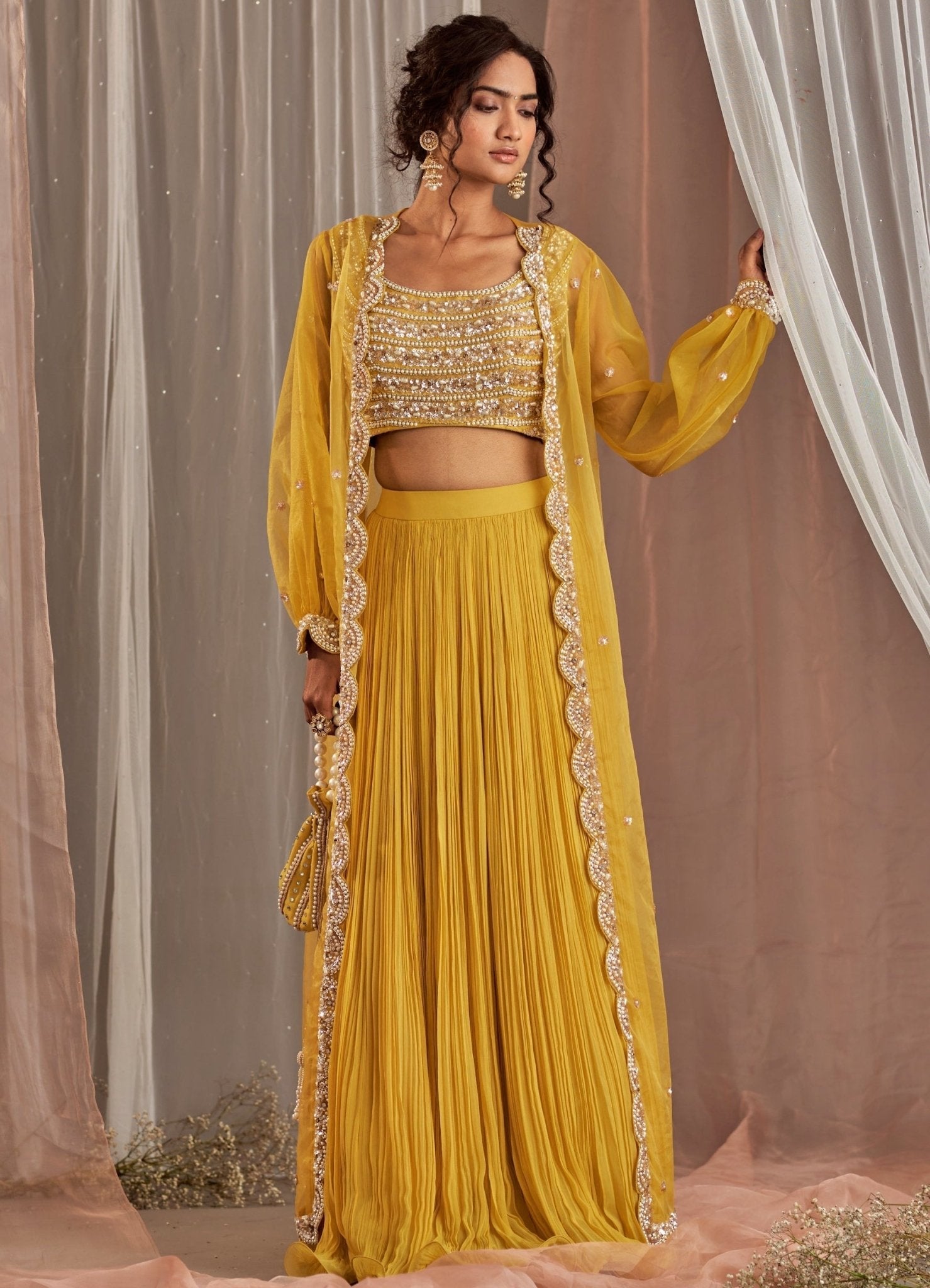 Nidhika Shekhar yellow georgette lehenga with long cape — destination wedding guest lehenga